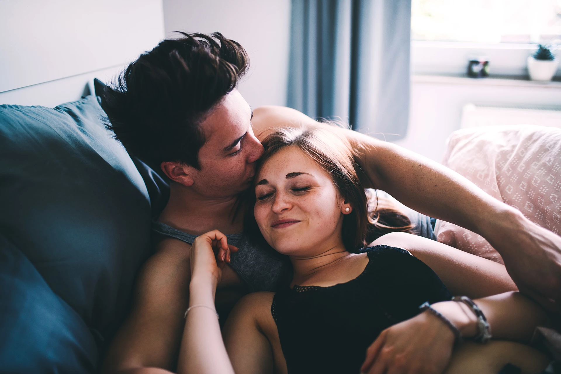 Couple embracing each other on couch