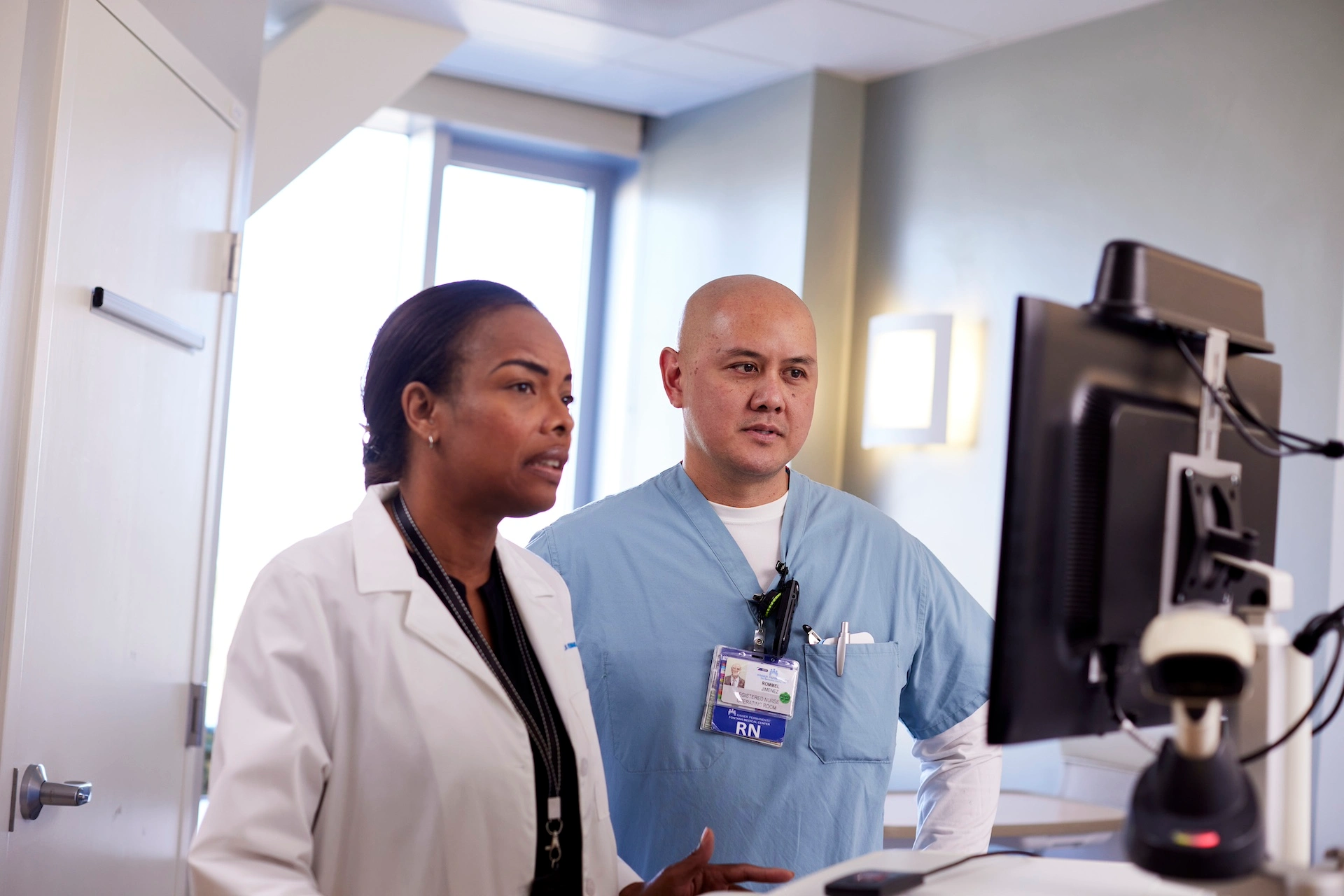 doctor and nurse looking at EHR on computer